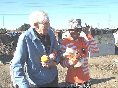 Paddy and Gladys taking food to the people - Gladys has commandeered Paddy's hat!