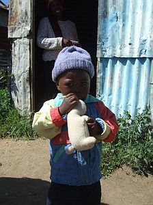 Baby David in front of his home