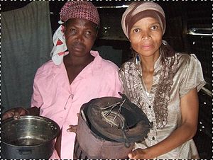 Sara with her cooking equipment - a battered paraffin stove and 1 pan