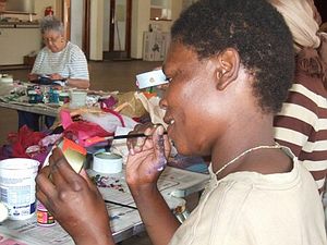 Agnes painting a candle tin