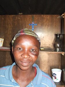 Gladys who helped make the crosses, in one of the shacks - beauty in the midst of desolation. Unfortunately, the injury on Gladys face was caused when she was mugged.